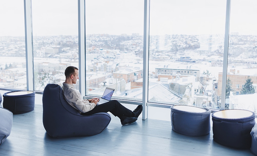ceo in nordics working on computer while snowing